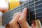 hand on the guitar fretboard