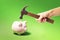 Hand with a hammer smashes a piggy bank. Money shortage concept