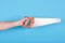 Hand with handsaw, carpentry and construction tool. Isolated on blue background