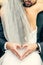 Hand, heart and bride and groom hug at their wedding, happy and relax while sharing an intimate moment. Hands, love and