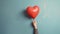 Hand with heart shaped balloon, Valentines Day
