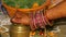 The hand of a Hindu bride with gold Jewelry.