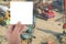 hand hold blank white card over blur Construction site with tractors