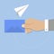 Hand hold blue postal envelope, flying paper plane. Mail delivery