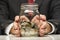 Hand hold coins in clear bottle