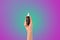 Hand hold cosmetic skincare dropper bottle. serum on neon colorful background.beauty banner