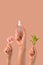 Hand hold cosmetic skincare on pink background with leaf and flower. organic natural beauty product