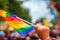 Hand hold a gay lgbt flag at LGBT gay pride parade festival