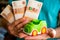Hand hold green toy car and russian money.fixed rate for car loan, or Saving money for car, trade car for cash, finance