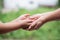 Hand hold mom Concept Love the giver Of mothers with children On blurred background nature