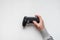 Hand hold new joystick isolated. Gamer play game with gamepad controller. Gaming man holding simulator joypad. Person with keypad