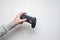 Hand hold new joystick isolated. Gamer play game with gamepad controller. Gaming man holding simulator joypad. Person with keypad