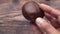 hand hold a raw champignon mushroom close up