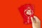 Hand Hold red envelope for Chinese New Year or Lunar New Year celebrations mean all things going smooth and well.