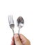 Hand hold Stainless steel fork and spoon isolated on white background