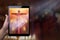 hand hold tablet screen with jesus on the cross  worship from home streaming of church service