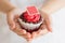 Hand hold valentines cupcake