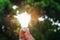 hand holdging light bulb with solar energy. power eco