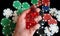 A Hand Holdind Red Dice on a Black Background