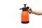 Hand holding an air pressure spray bottle