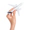 Hand holding airplane isolated over white background. Flight, travel concept