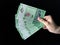 Hand holding a Bank Negara Malaysia 5 Ringgit Moneys over black background
