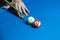 Hand holding billiard stick cue on a pool table ready to shot ball