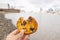 Hand Holding a Bitten Chocolate Chips Cookie with a Blurry River as Background