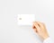 Hand holding blank white credit card mockup isolated.