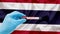 Hand holding blood collection tubes on monkeypox test positive results with thailand flag