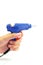 Hand holding blue glue gun