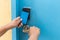 Hand holding blue hotel keycard in front of electric door