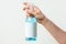 Hand holding the bottle with blue sanitizer mockup