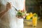 Hand holding a bowl with salad, fork in another