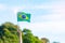 Hand holding Brazil flag on blue sky background. September Independence day and Happy celebration concepts