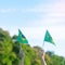 Hand holding Brazil flag on blue sky background. September Independence day and Happy celebration concepts