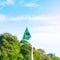 Hand holding Brazil flag on blue sky background. September Independence day and Happy celebration concepts