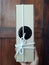 Hand holding brown paper gift box, tied white rope