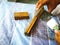 Hand holding brush shows how to apply stain to wood planks.