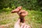 A hand holding a bunch of honey fungus