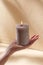 hand holding burning aroma candle on palm