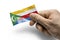 Hand holding a card with a national flag the Comoros