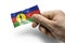 Hand holding a card with a national flag the New Caledonia