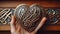 Hand Holding Celtic Heart Carving