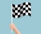 Hand holding checkered race finish flag