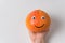 Hand holding cheerful orange. Orange smiley on white background. Food with Funny Faces