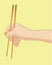 Hand holding chopstick