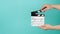 Hand is holding clapper board or clapperboard or movie slate.It is used in film production and movies industry on green mint or