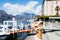 Hand holding cone of Gelato, Italian ice-cream with blur background of a landscape view of Lake Como in Italy.