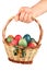 Hand Holding Easter Basket Filled Colored Eggs